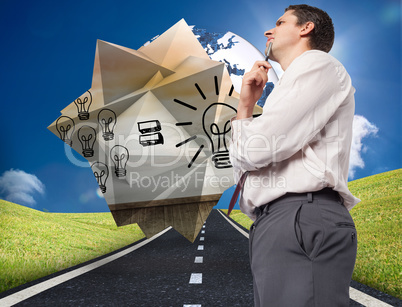 Composite image of thoughtful businessman holding pen to chin