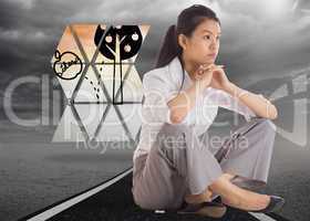 Composite image of thinking businesswoman sitting with hands tog