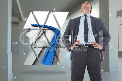 Composite image of serious businessman with hands on hips