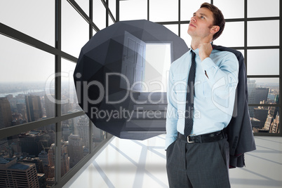 Composite image of serious businessman holding his jacket