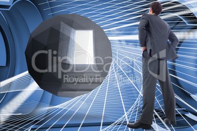 Composite image of businessman standing with hands on hips