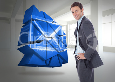 Composite image of smiling businessman with hands on hips