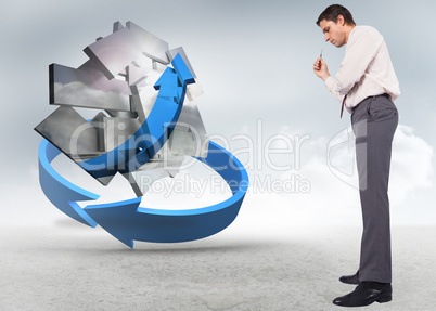 Composite image of thinking businessman holding pen