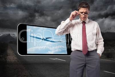 Composite image of thinking businessman touching his glasses