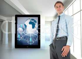 Composite image of happy businessman standing with hand in pocke