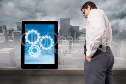 Composite image of thinking businessman touching his glasses