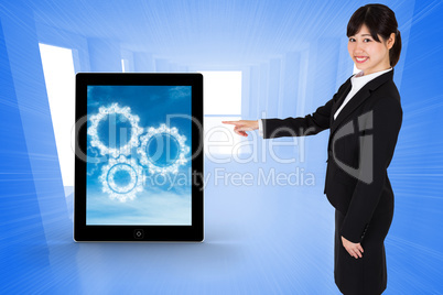 Composite image of smiling businesswoman pointing