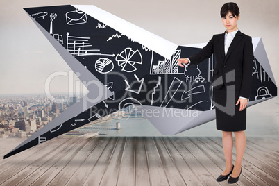 Composite image of focused businesswoman pointing