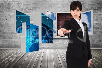 Composite image of focused businesswoman pointing