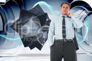 Composite image of serious businessman holding his jacket