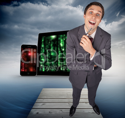 Composite image of thinking businessman holding pen