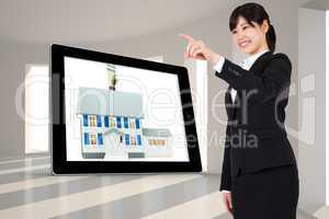 Composite image of smiling businesswoman pointing