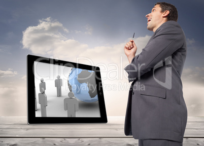 Composite image of thoughtful businessman holding pen