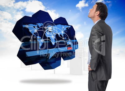 Composite image of serious businessman with hand on hip