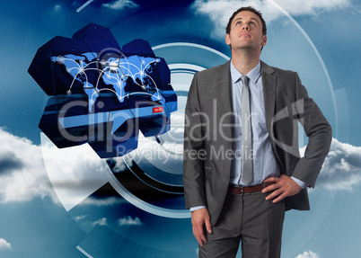 Composite image of serious businessman with hand on hip