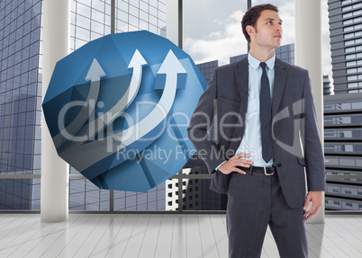 Composite image of serious businessman with hand on hip