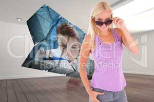 Composite image of charming woman peeking over her sunglasses
