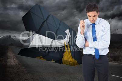 Composite image of thinking businessman holding pen