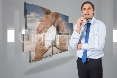 Composite image of thinking businessman biting glasses