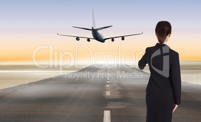 Composite image of businesswoman pointing