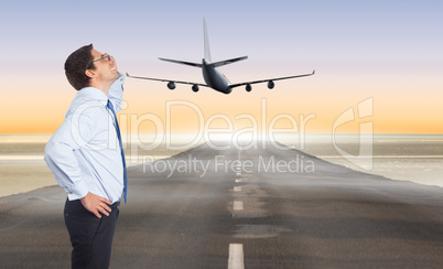 Composite image of thinking businessman tilting glasses