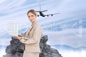 Composite image of businesswoman with a laptop