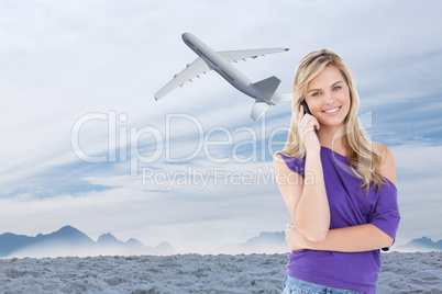Composite image of happy blonde woman using her cellphone