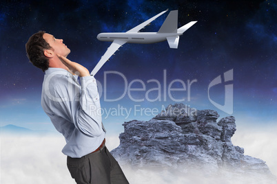 Composite image of businessman standing with arms pushing up