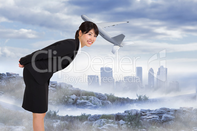 Composite image of smiling businesswoman bending