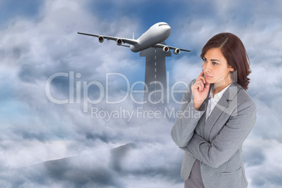 Composite image of focused businesswoman