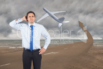 Composite image of thinking businessman scratching head