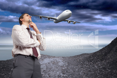 Composite image of thoughtful businessman holding pen to chin