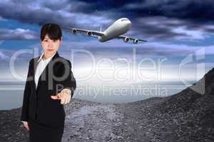 Composite image of focused businesswoman pointing