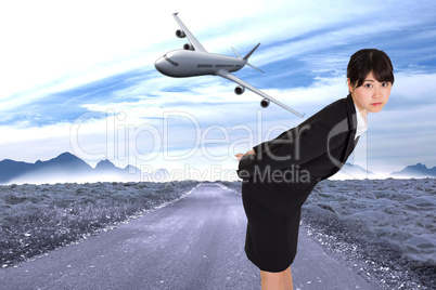 Composite image of serious businesswoman bending