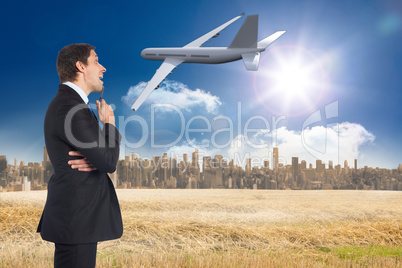 Composite image of thinking businessman holding pen