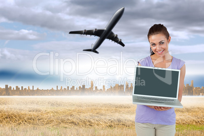 Composite image of smiling young female with her laptop Composite image of smiling young female with her laptop