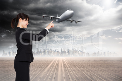 Composite image of smiling businesswoman pointing