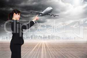 Composite image of smiling businesswoman pointing