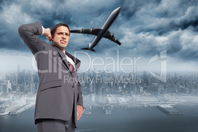 Composite image of thinking businessman scratching head