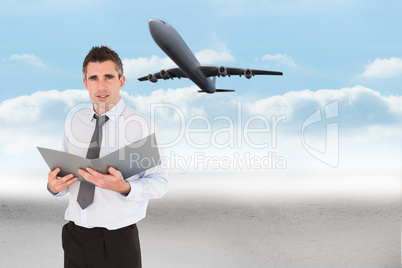 Composite image of portrait of a man holding a binder