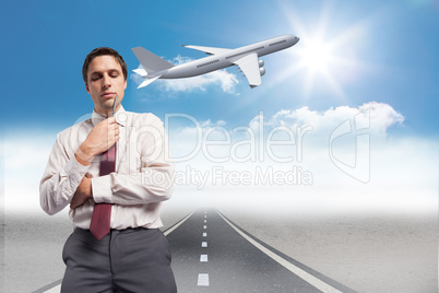 Composite image of thoughtful businessman holding pen to chin