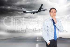 Composite image of thinking businessman touching his chin