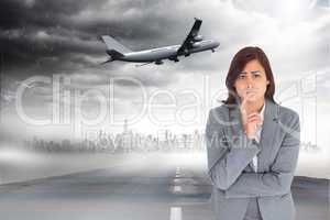 Composite image of worried businesswoman