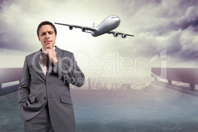 Composite image of thoughtful businessman with hand on chin