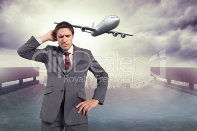 Composite image of thinking businessman scratching head