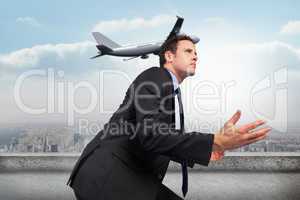 Composite image of businessman posing with arms out