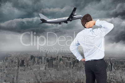 Composite image of thinking businessman scratching head