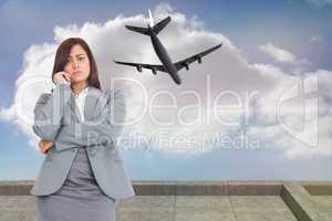 Composite image of worried businesswoman