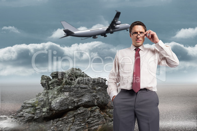 Composite image of thinking businessman touching his glasses