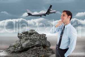 Composite image of thoughtful businessman with hand on chin